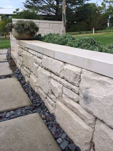landscape design and construction with a creative sandstone retaining wall and clean sandstone pathway design