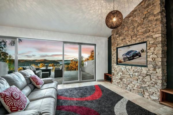 Enjoy your living room with a feature wall like this one of stone cladding by creative landscape solution experts.